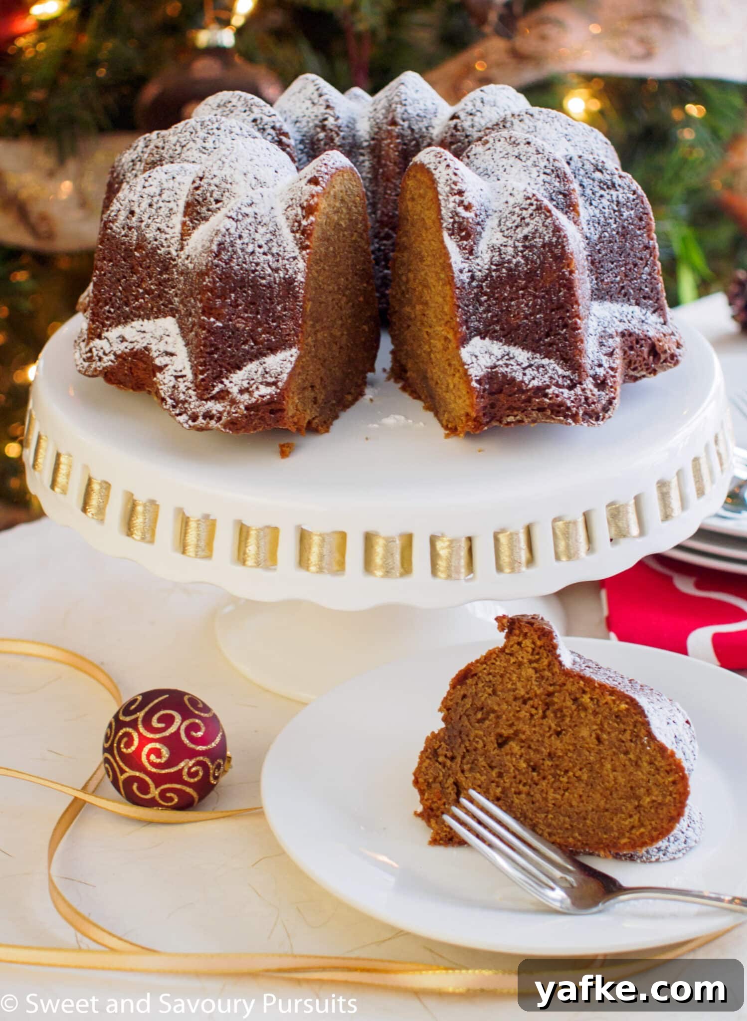 Gingerbread Bundt Cake with Warm Spiced Glaze 3 Gingerbread bundt cake with slice cut out and served on dish.