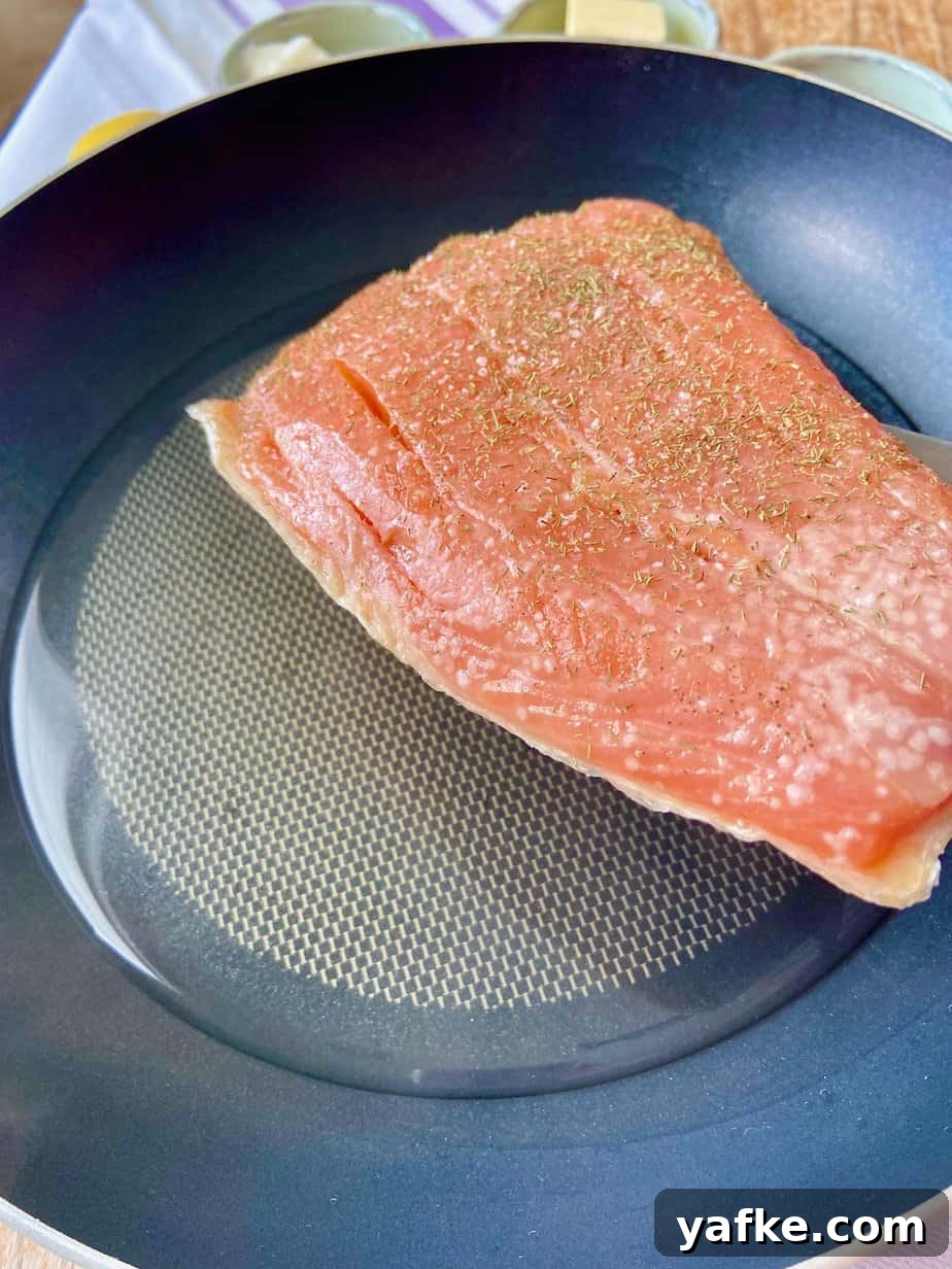 Smoked Salmon Spread with Cream Cheese, Dill and Lemon 4 Fresh salmon fillet in skillet with a little water.