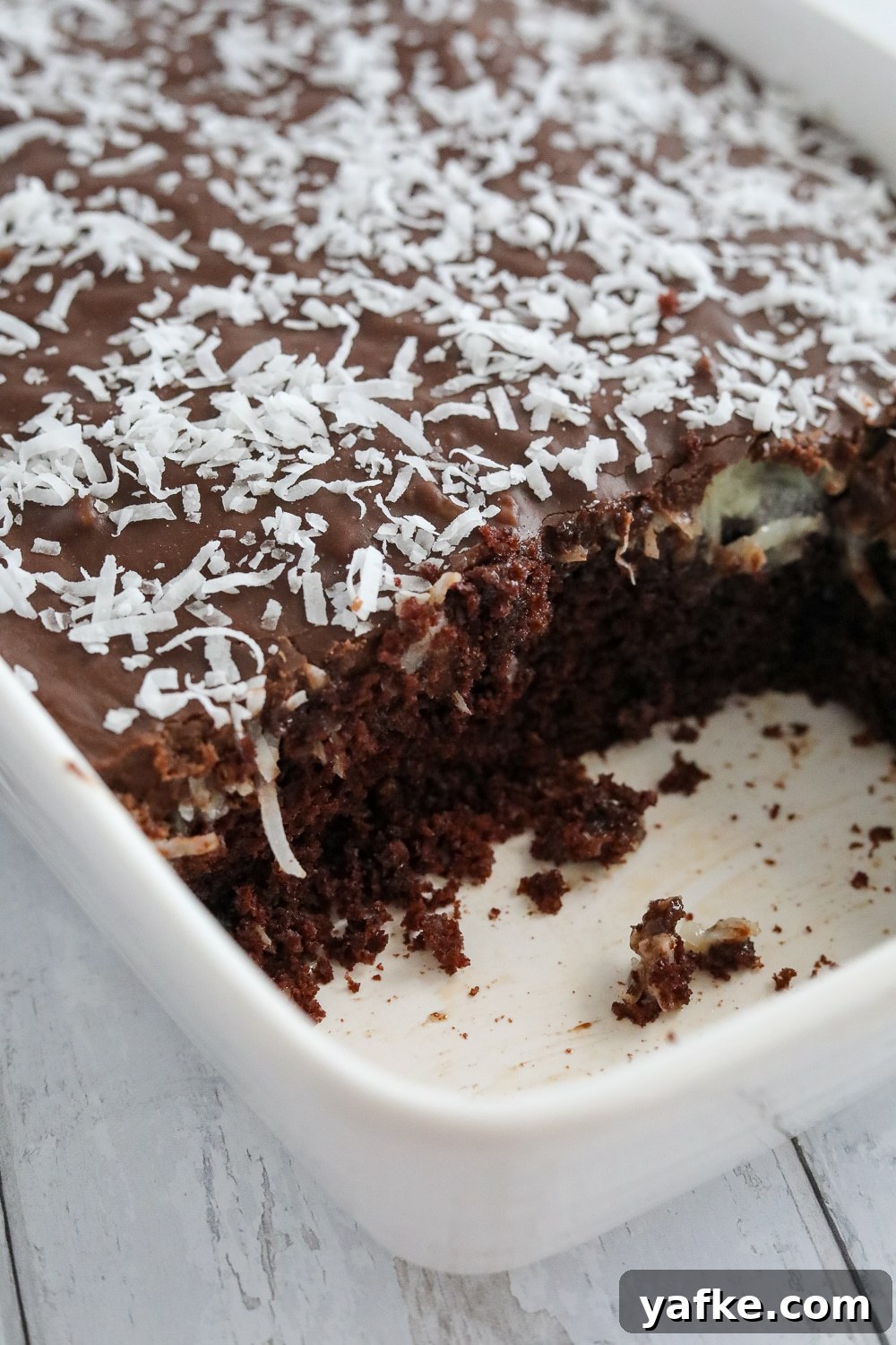 Decadent Chocolate Mound Cake Recipe 6 chocolate mound cake with coconut filling and fudge frosting on a cake stand