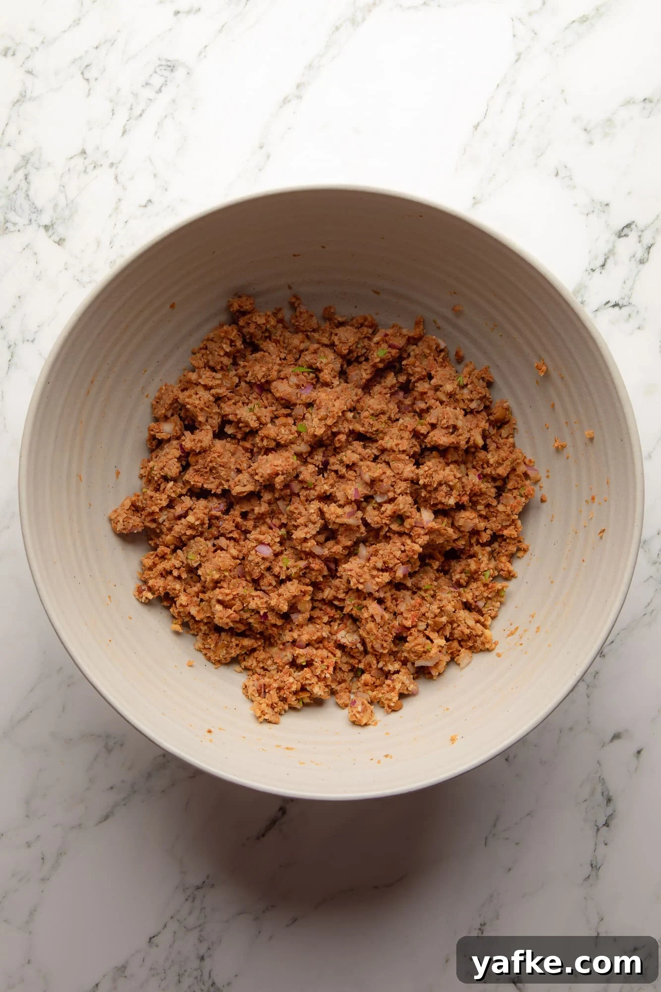 Vegan Lentil Burgers with Garlic and Herbs 6 overhead view of the mashed lentil mixture for lentil burgers in a large bowl.