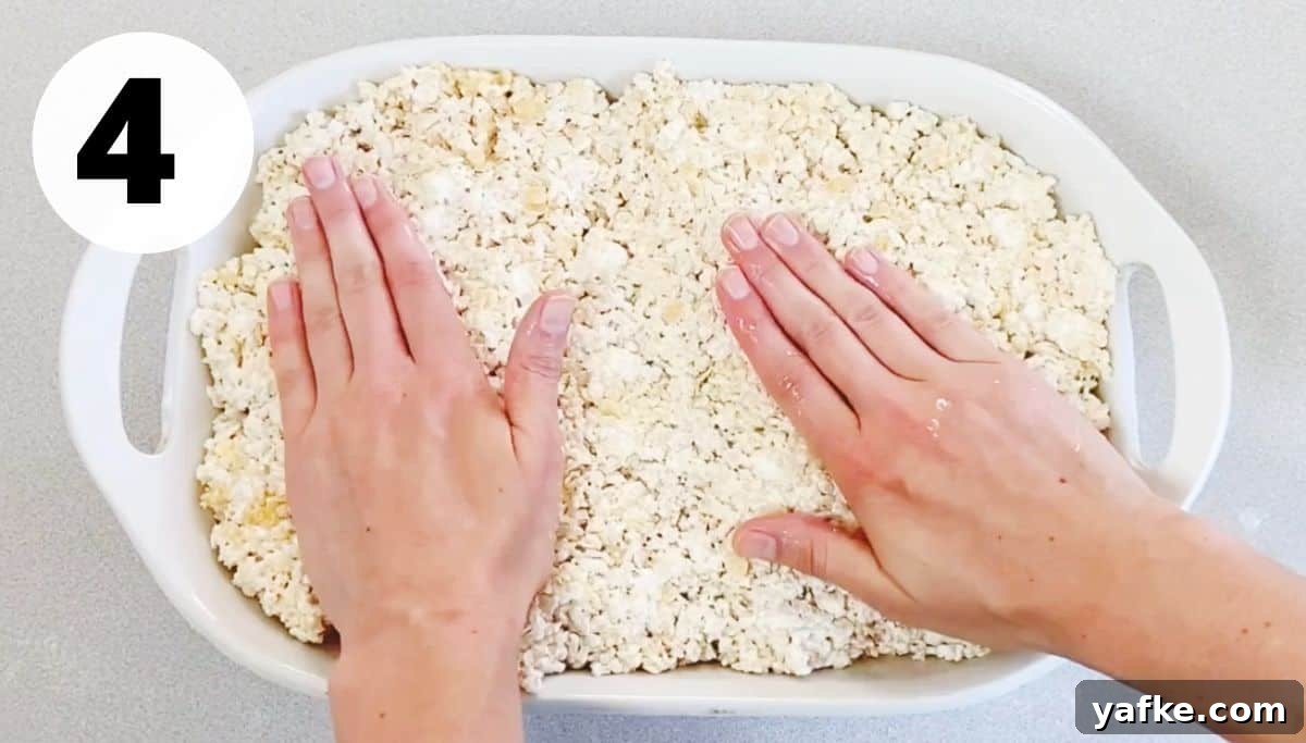 Rice Krispie Treats with Marshmallow Fluff 6 hands patting down rice krispie treats in pan.