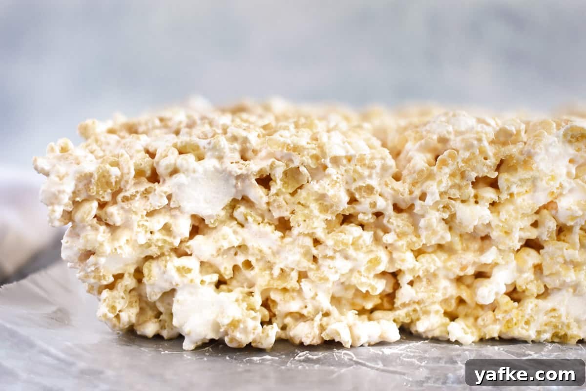 Rice Krispie Treats with Marshmallow Fluff 7 close up of side view of rice krispie treat.