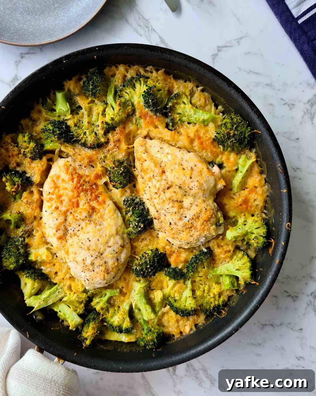 Overhead shot of a pan of freshly baked chicken and broccoli risoni 