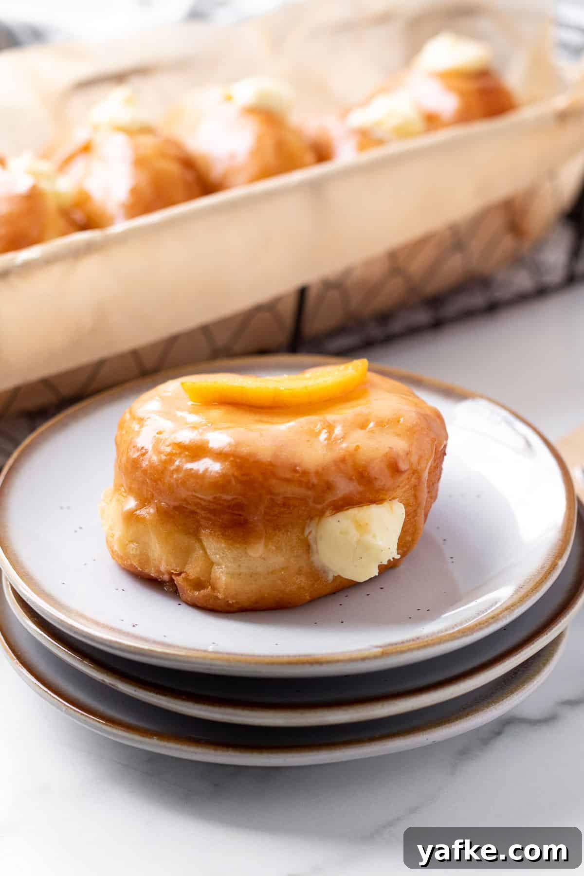 Peach Donuts with Peaches and Cream Filling 7 stack of plates with peach donut on top and basket of donuts in background