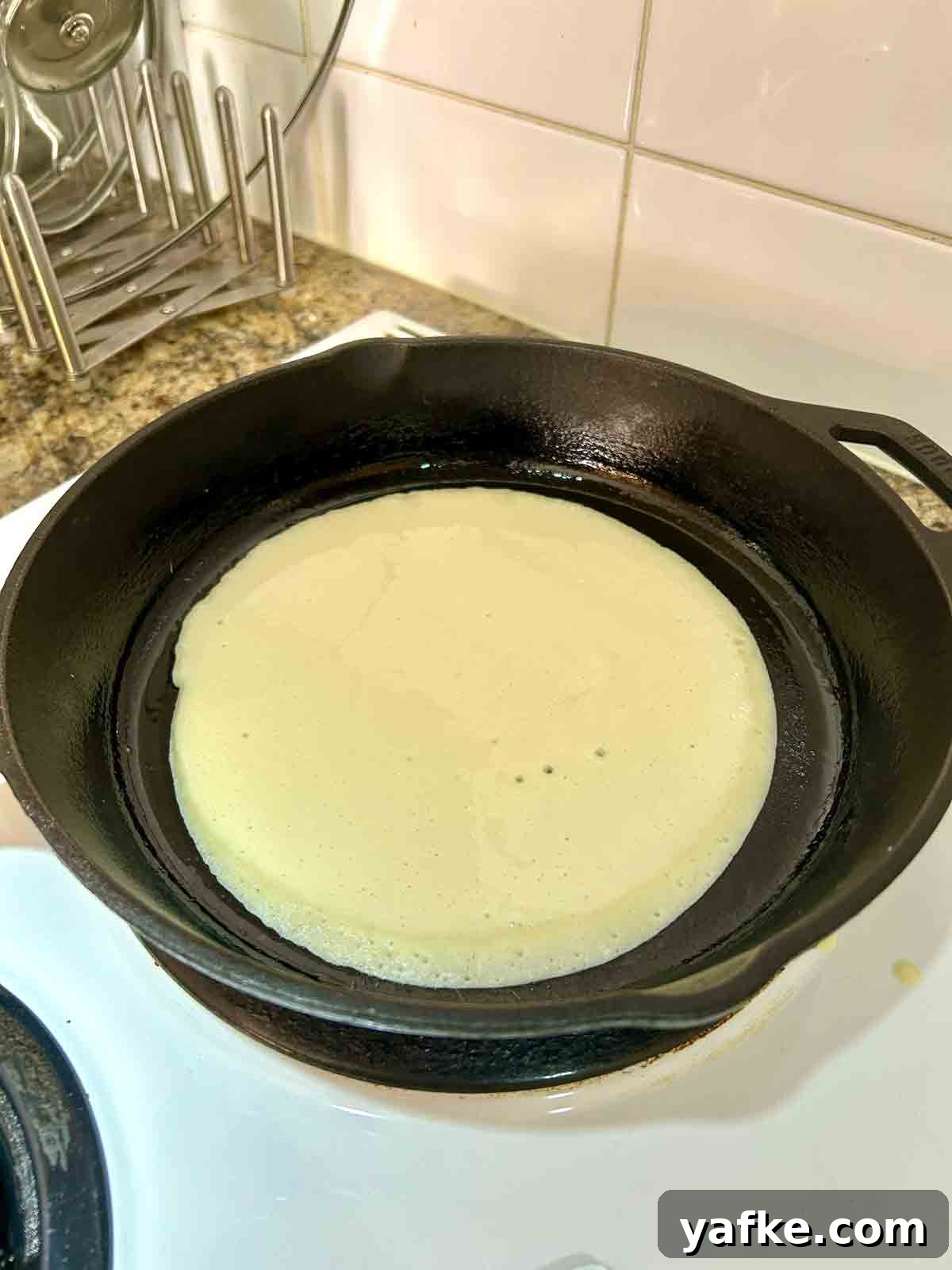 Authentic Swedish Pancake Recipe: Thin Crepe-Style Pancakes 5 batter poured into pan and swirled into circle.