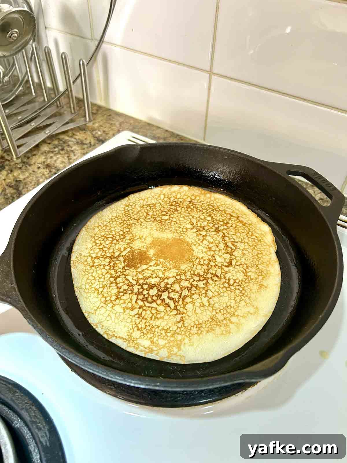Authentic Swedish Pancake Recipe: Thin Crepe-Style Pancakes 6 second side of pancake being cooked until golden brown.