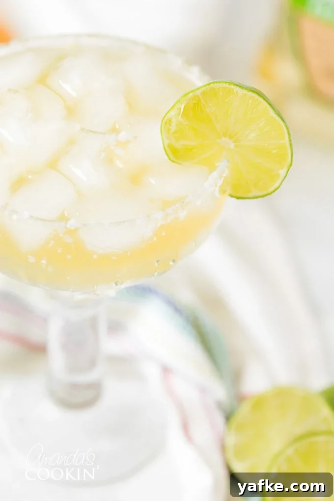 Learn how to make a margarita drink on the rocks. This classic cocktail is perfect any time of year. CLOSE UP OF MARGARITA ON THE ROCKS