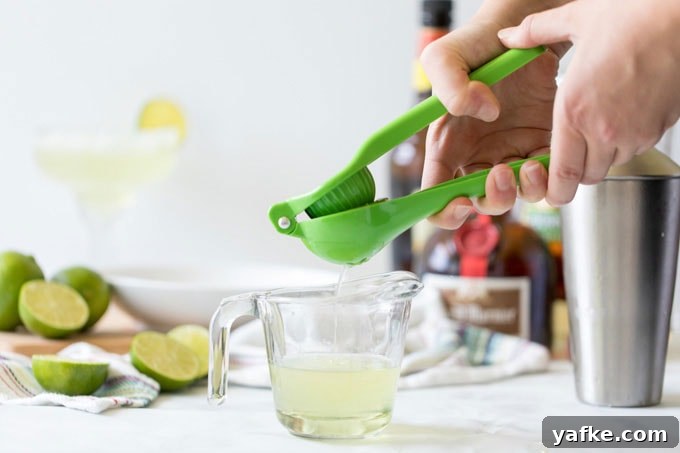 Classic Margarita Cocktail: Recipe, Tips and Variations 2 squeezing the juice of a lime