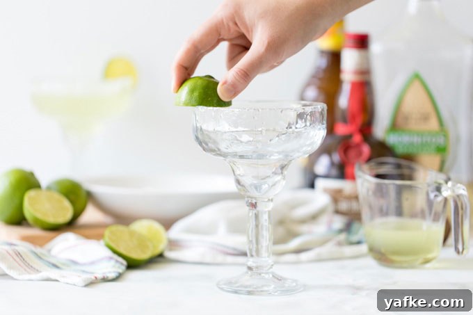 Classic Margarita Cocktail: Recipe, Tips and Variations 3 rubbing lime on a glass rim