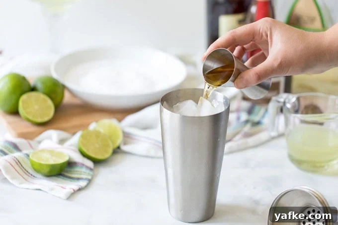 Classic Margarita Cocktail: Recipe, Tips and Variations 5 adding orange liqueur to cocktail shaker