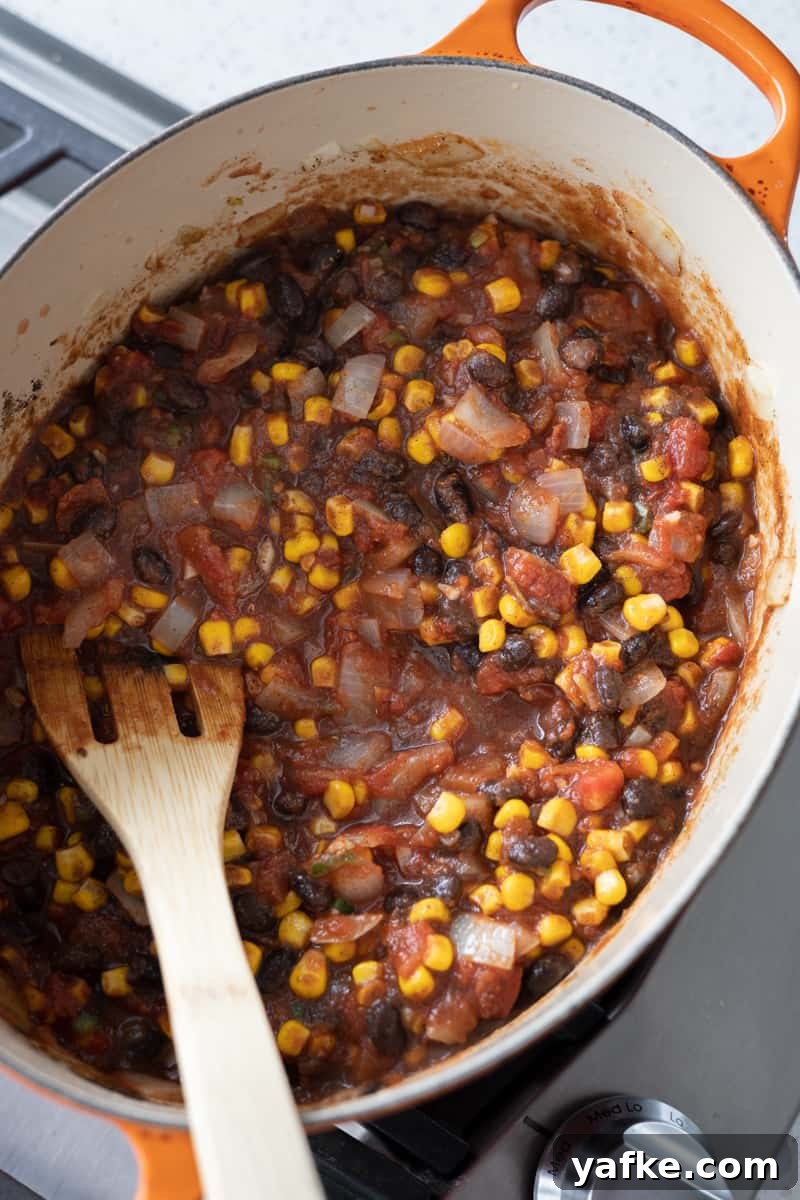 Chicken Tortilla Soup Recipe with Avocado and Lime 5 Jalapeño, tomatoes, corn, black beans, tomato paste and spices added to the Dutch oven.