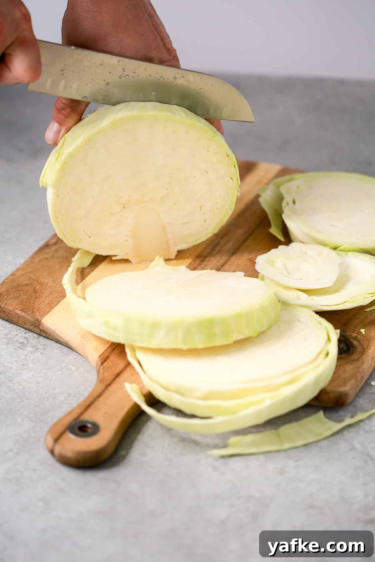 Crispy Roasted Cabbage Steaks with Garlic and Parmesan 2 slicing cabbage steaks on a cutting board