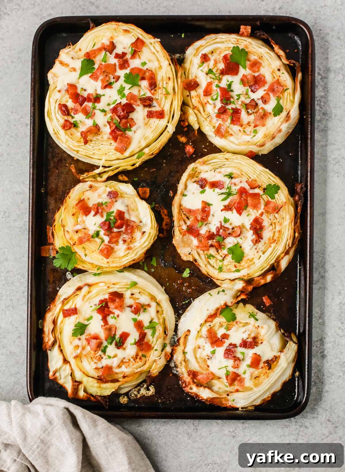 Crispy Roasted Cabbage Steaks with Garlic and Parmesan 3 cabbage steaks on a baking sheet