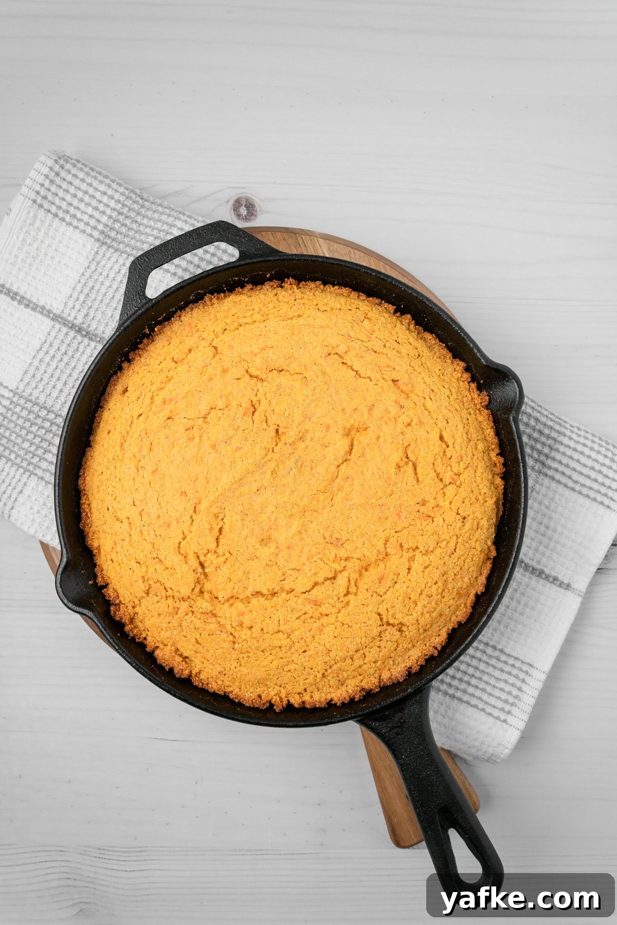 Southern Sweet Potato Cornbread with Maple and Pecans 6 An overhead image of cooked sweet potato cornbread.