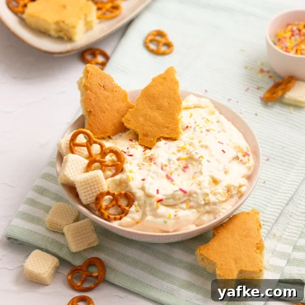 Bowl of homemade Christmas Tree Cake Dip topped with sprinkles.