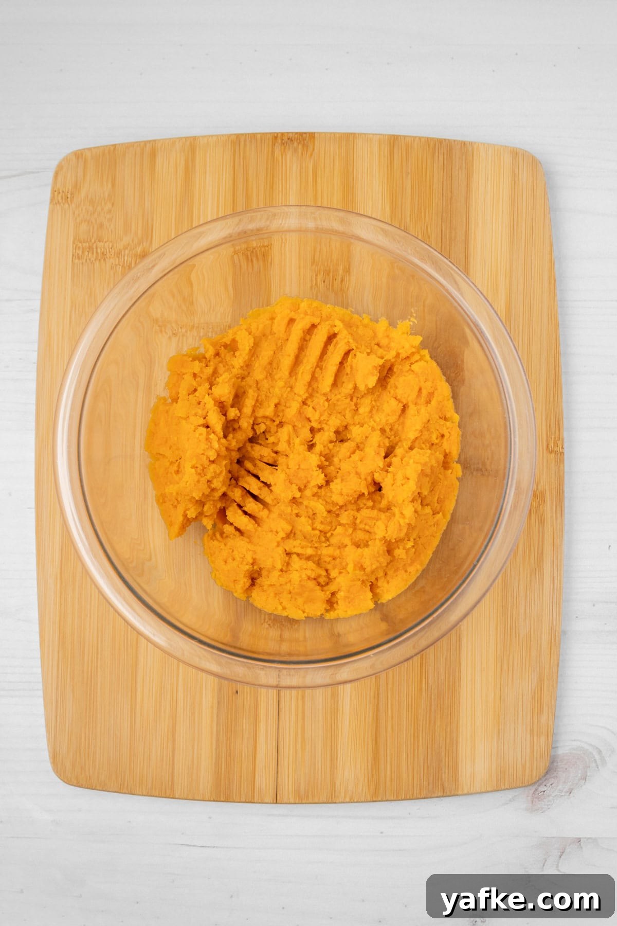 Southern Sweet Potato Cornbread with Maple and Pecans 4 An overhead image of mashed sweet potatoes in a bowl.