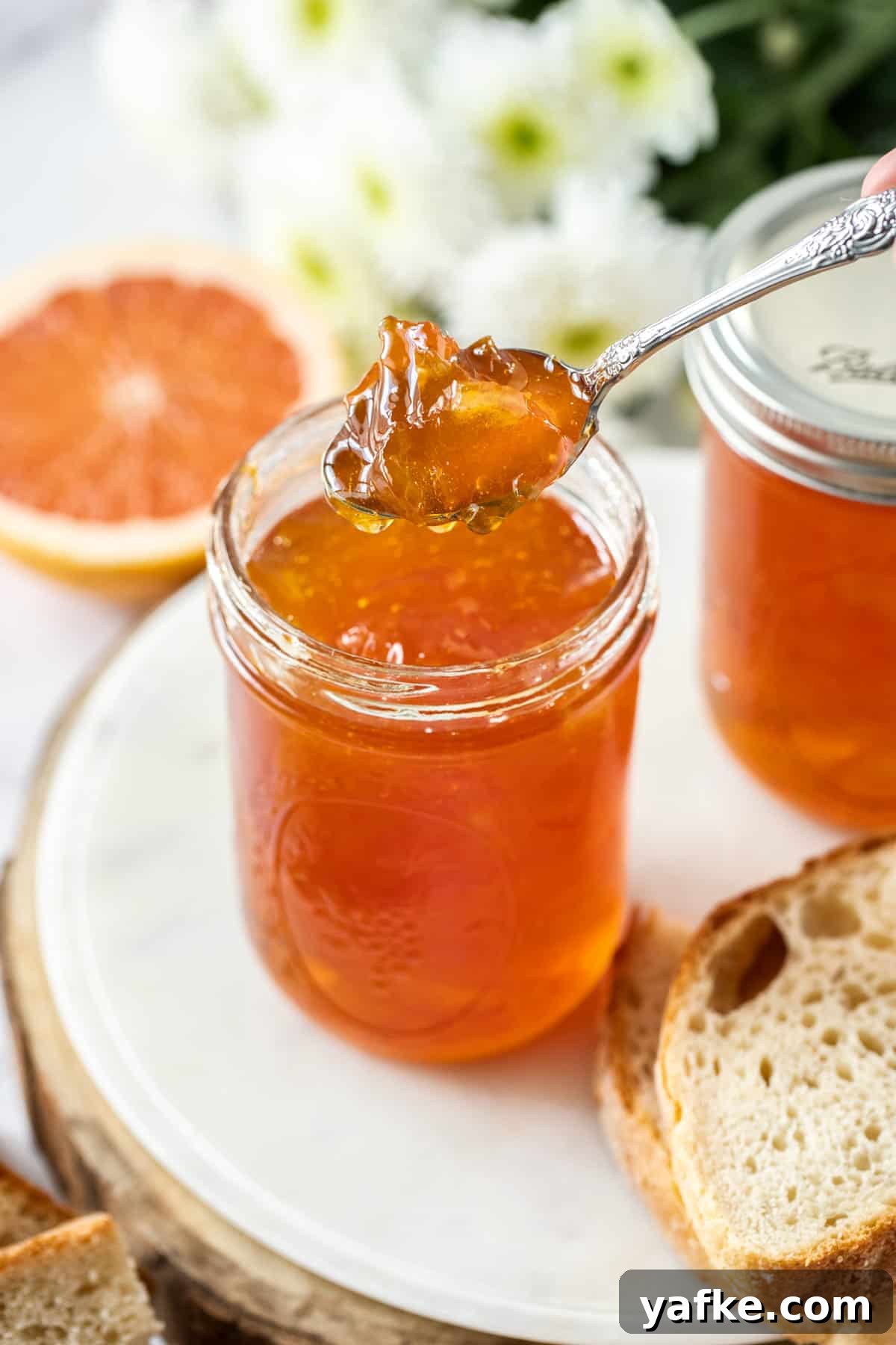 25 Homemade Edible Gift Ideas for Any Occasion 18 a spoon scooping into a jar of marmalade