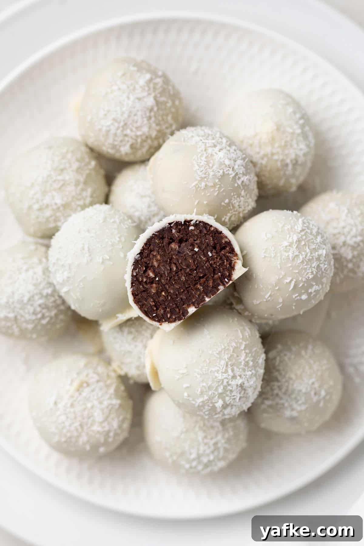 25 Homemade Edible Gift Ideas for Any Occasion 24 Round white plate with a stack of Coconut Truffles