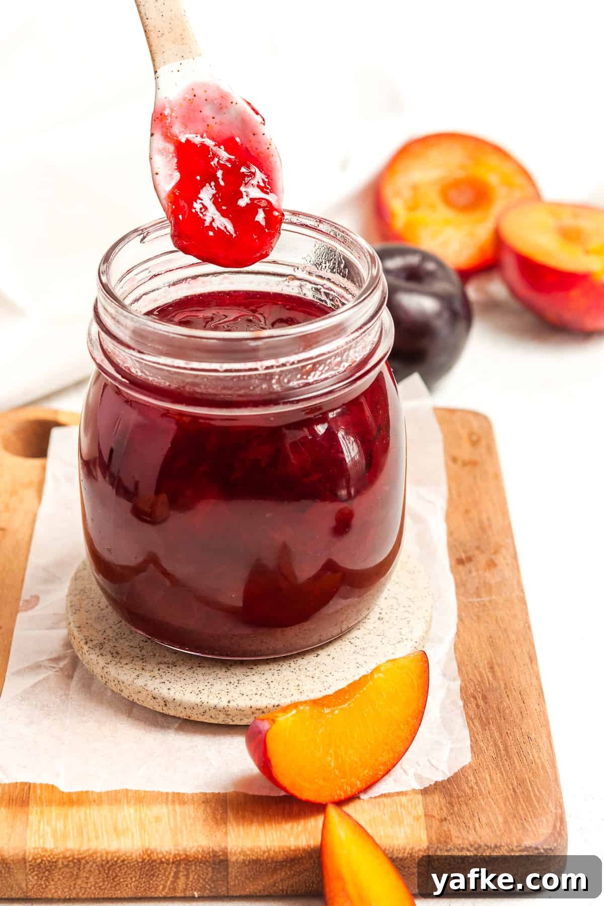 25 Homemade Edible Gift Ideas for Any Occasion 8 Spoon dipping into a jar of jam.