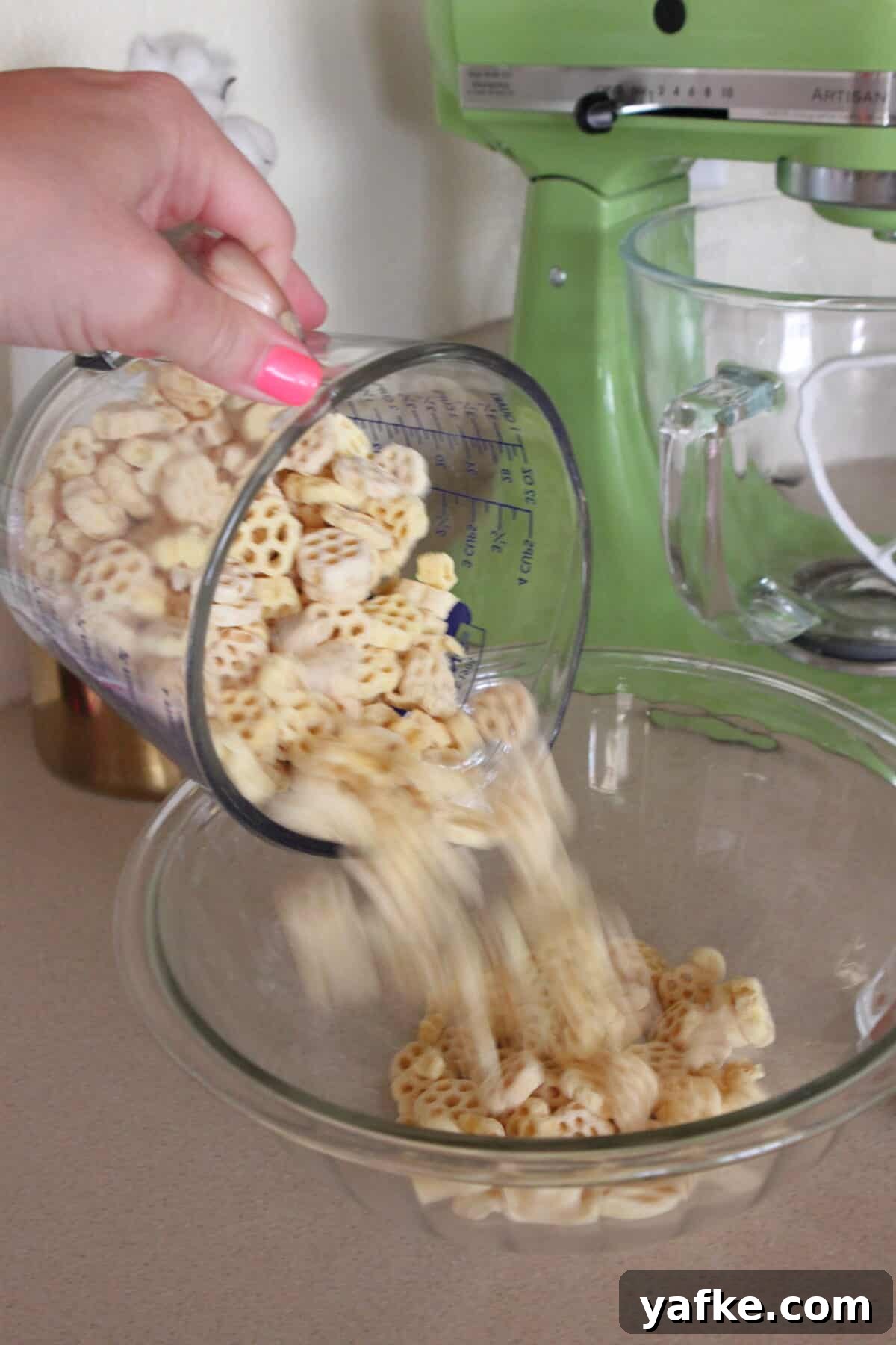 White Chocolate Churro Crunch Snack Mix Recipe 3 pouring honey comb cereal into large mixing bowl