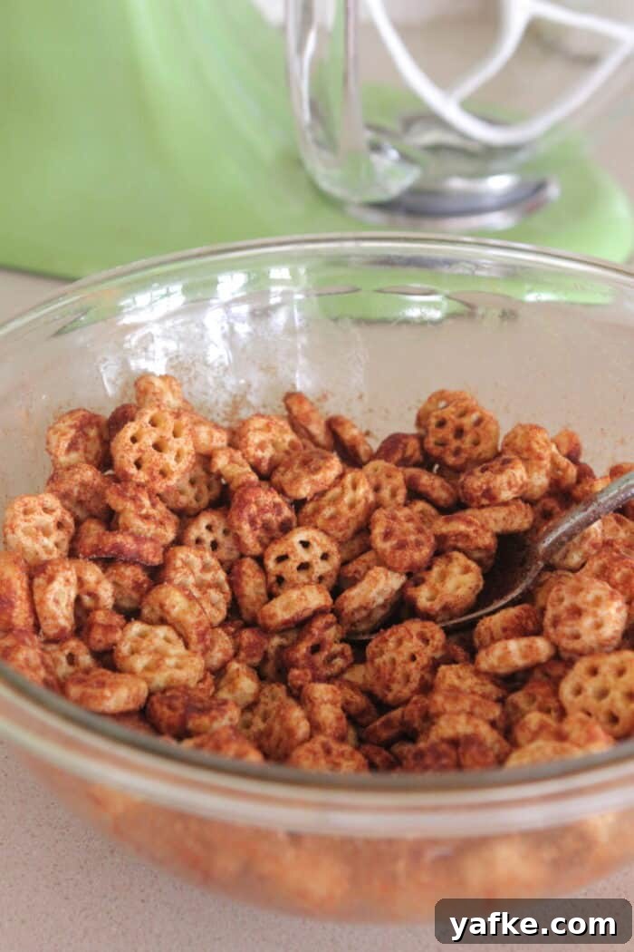 White Chocolate Churro Crunch Snack Mix Recipe 6 cinnamon sugar mixed into cereal mixture in mixing bowl