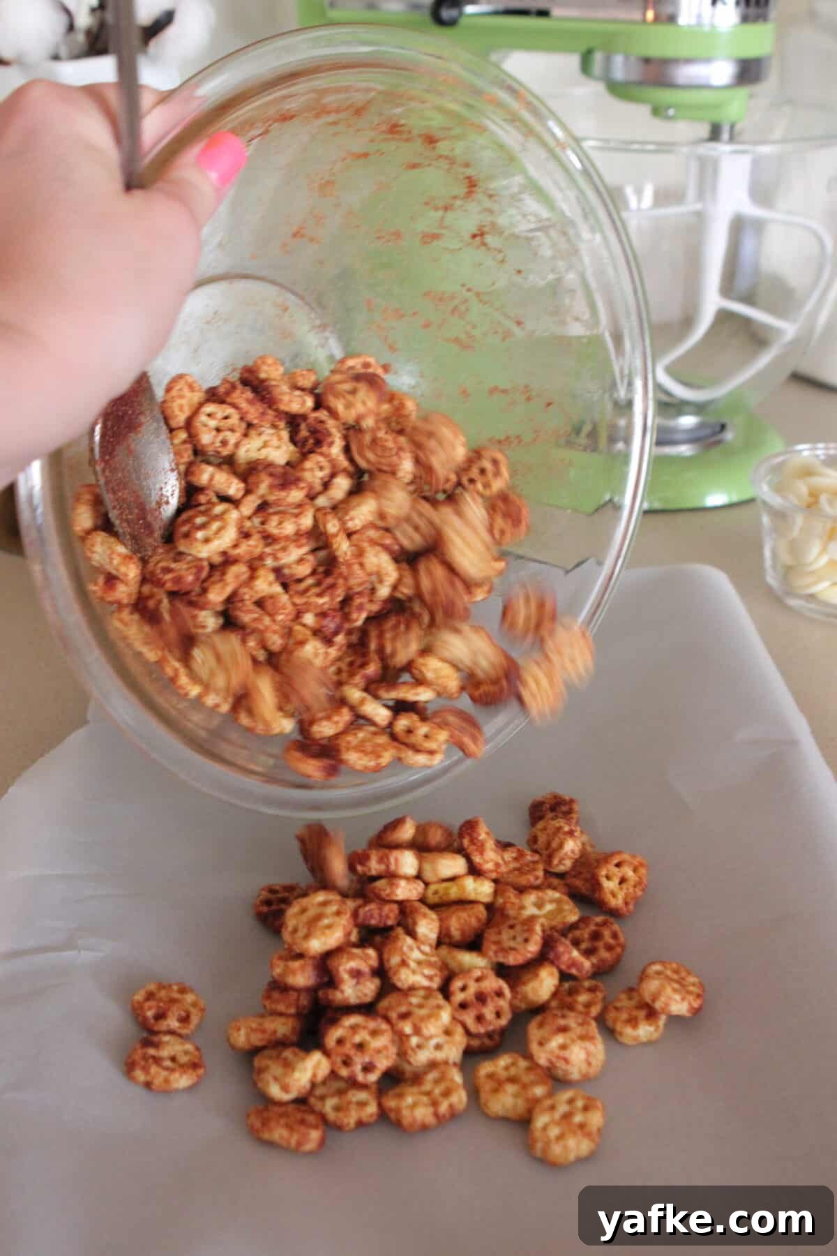 White Chocolate Churro Crunch Snack Mix Recipe 7 pouring snack mix onto baking sheet to bake