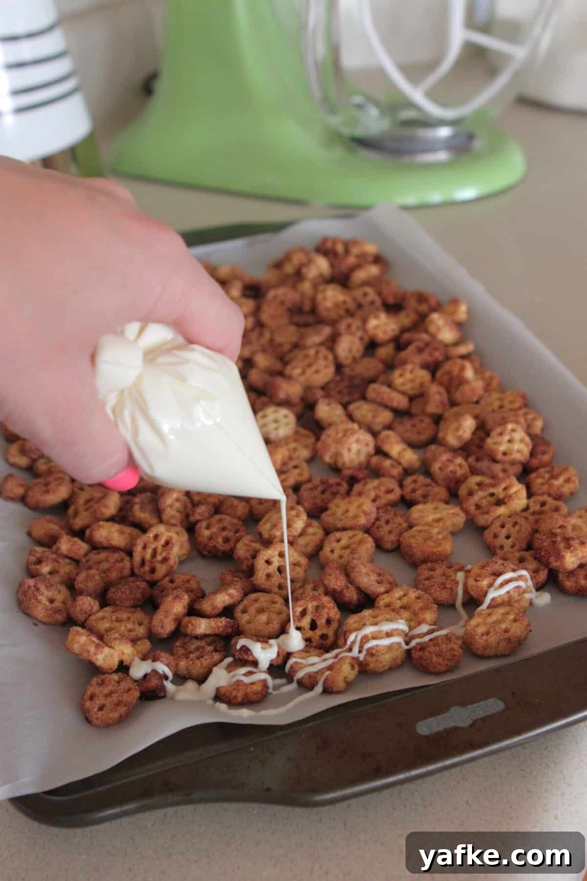 White Chocolate Churro Crunch Snack Mix Recipe 9 drizzling white chocolate over snack mix recipe