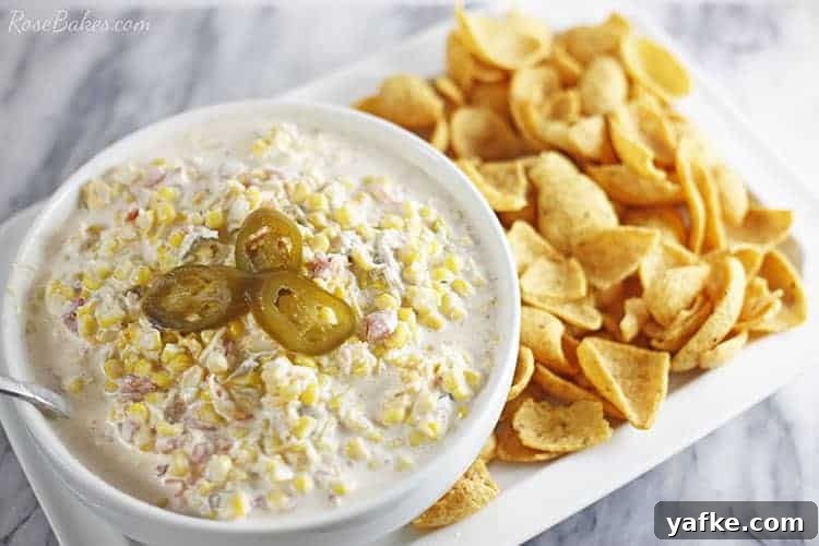 Creamy Corn Dip with Fritos 2 crack corn dip with fritos on a platter garnished with jalapenos