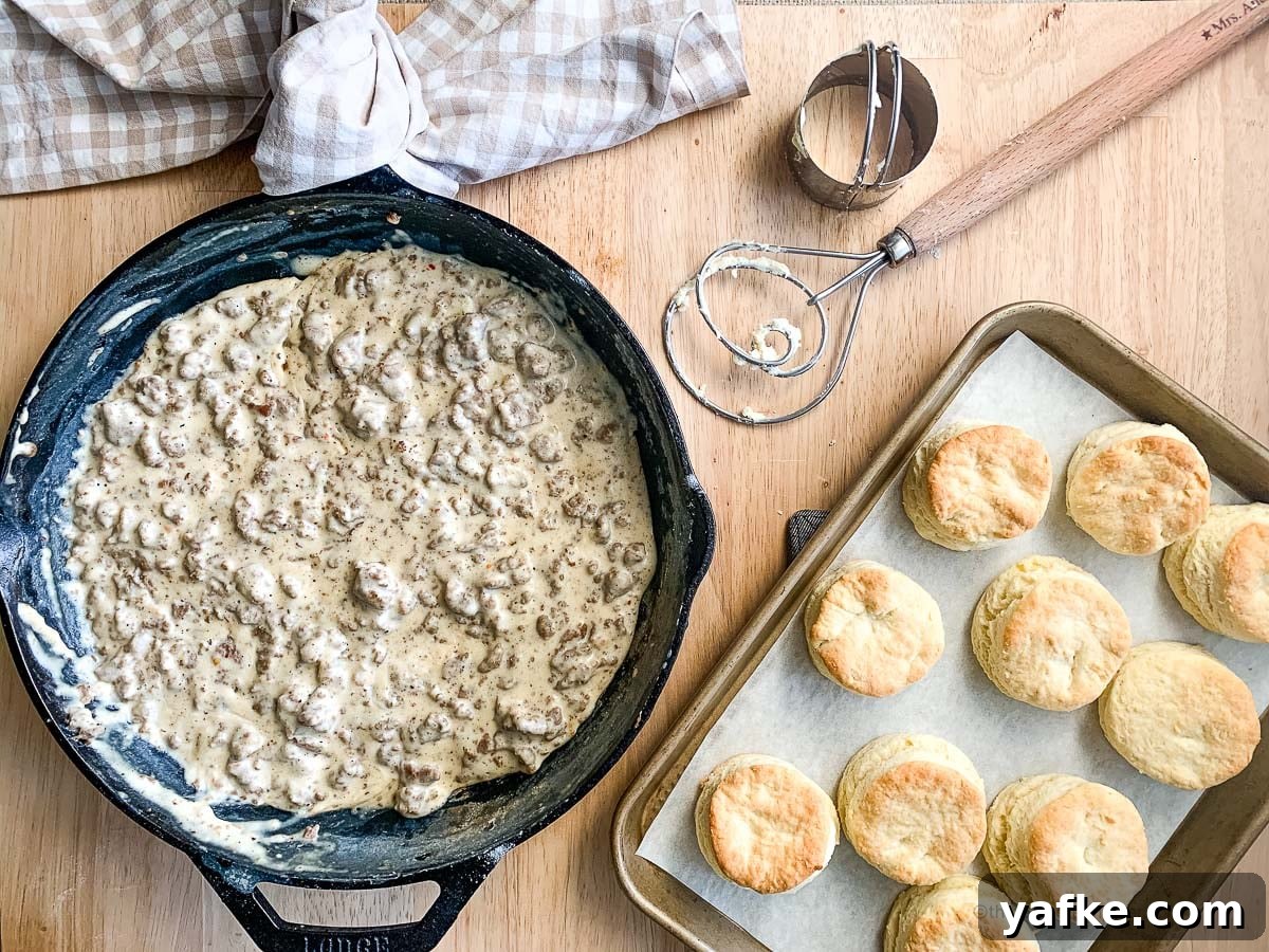 How to Make Homemade Sausage Gravy for Biscuits 2 a cast iron skillet of gravy sausage with a pan of freshly baked biscuits.