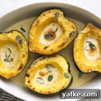 roasted acorn squash with sage cream sauce in baking dish