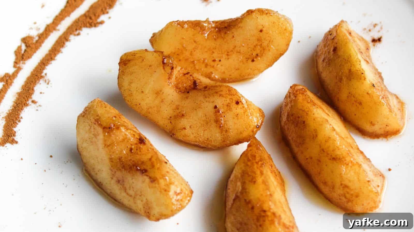 11 Air Fryer Dessert Recipes That Will Make You Ditch the Oven 11 Cinnamon apple slices on a white plate.