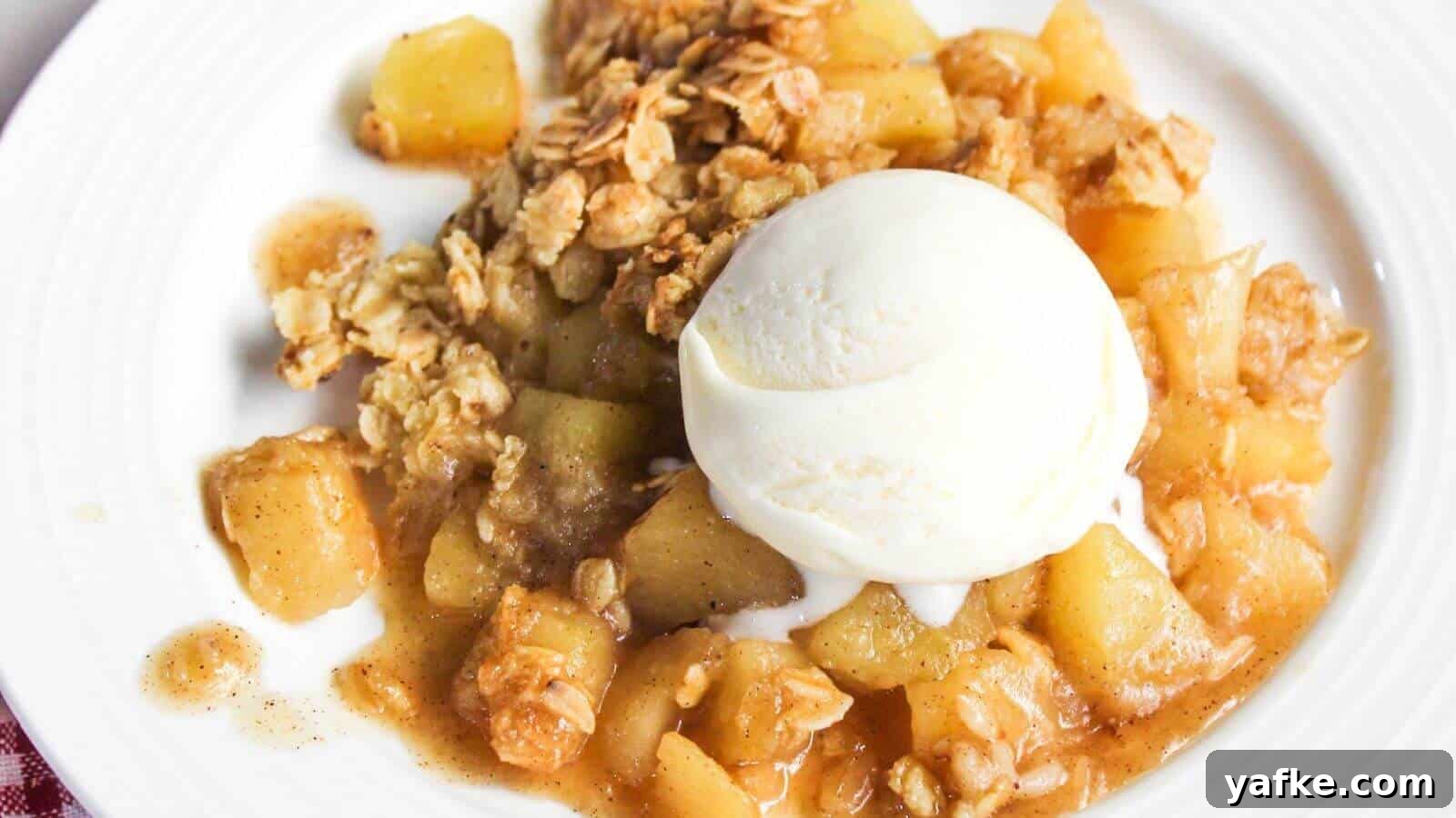 11 Air Fryer Dessert Recipes That Will Make You Ditch the Oven 12 A plate of apple crisp with chunks of apple, topped with a scoop of vanilla ice cream and an oat crumble topping.