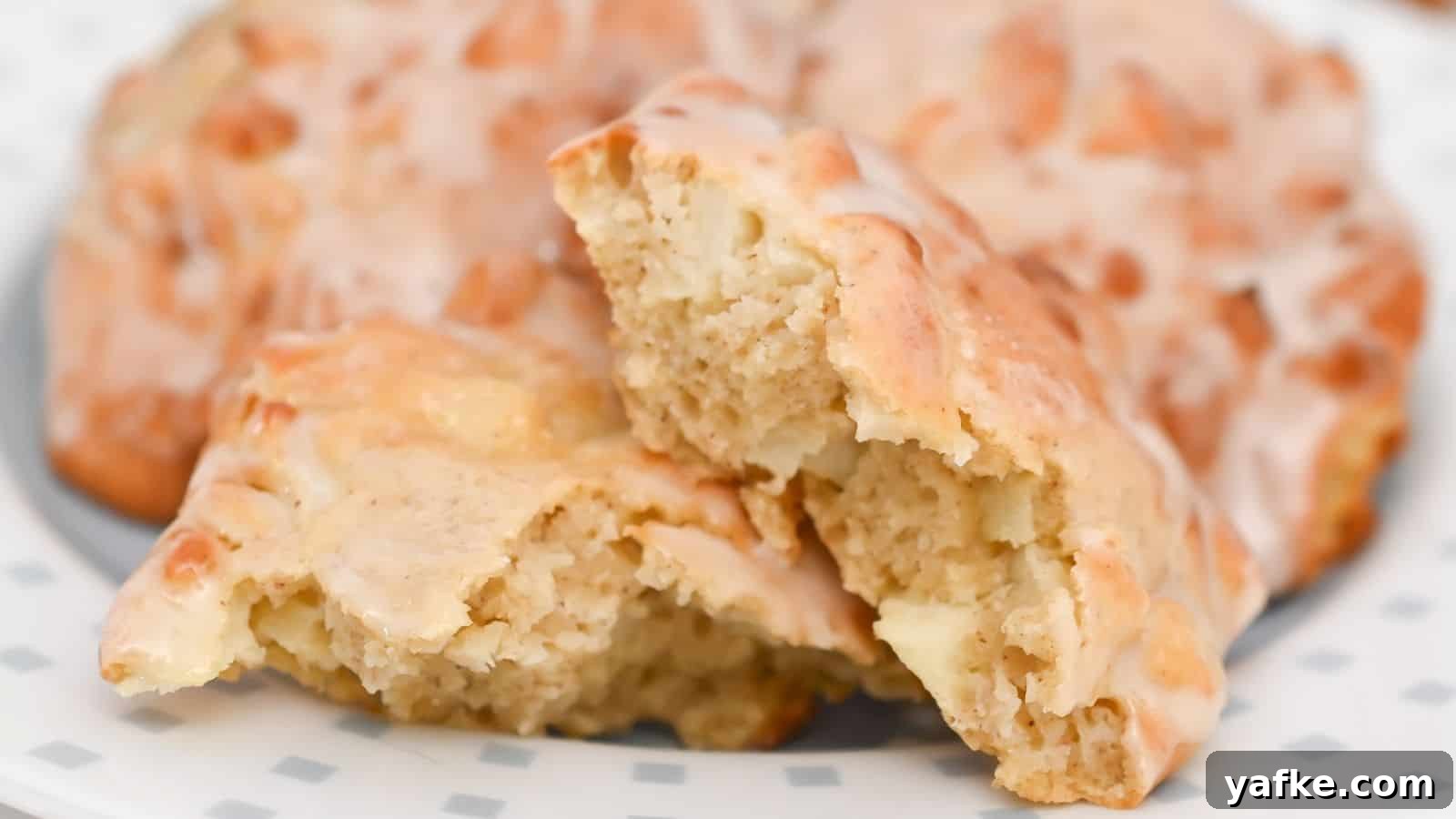 11 Air Fryer Dessert Recipes That Will Make You Ditch the Oven 9 Glazed apple cinnamon fritters on a plate with front one broken in half.