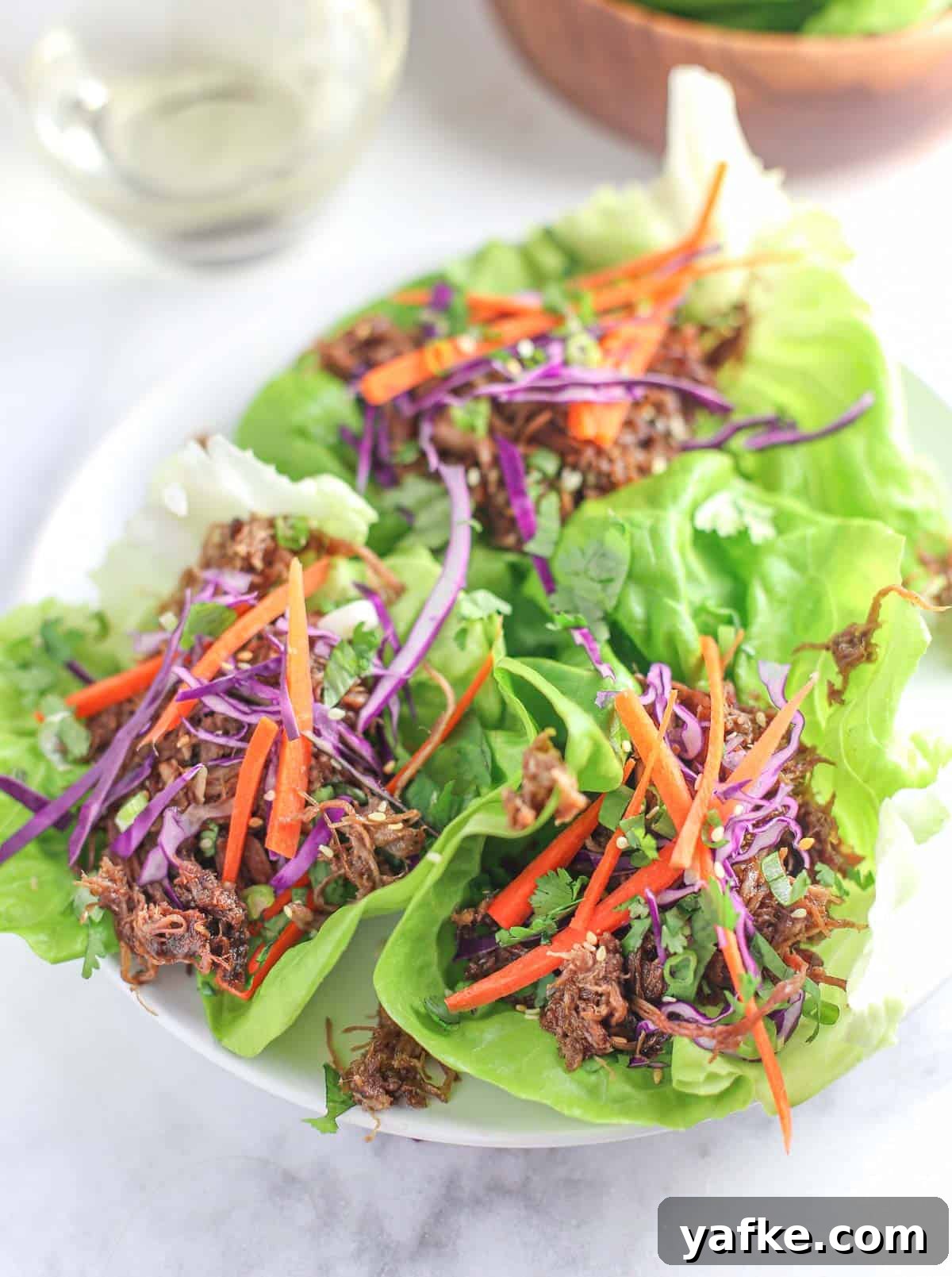 Smoked Pulled Pork Lettuce Wraps with Savory Soy Dipping Sauce 2 Pulled Pork Lettuce Wraps on a serving platter