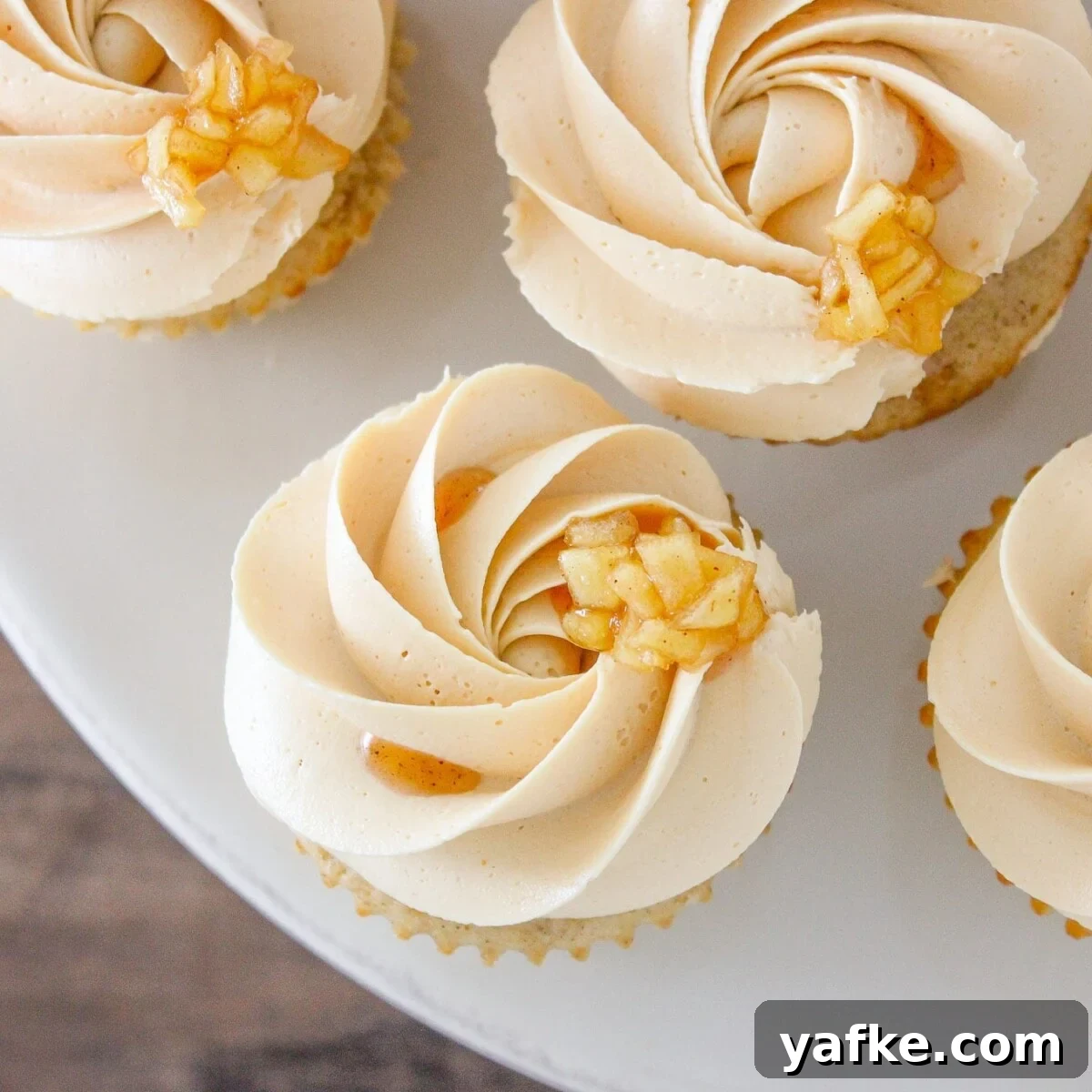 Caramel Apple Cupcakes Recipe with Salted Caramel Frosting 7 Caramel Apple Cupcakes on marble cake stand.