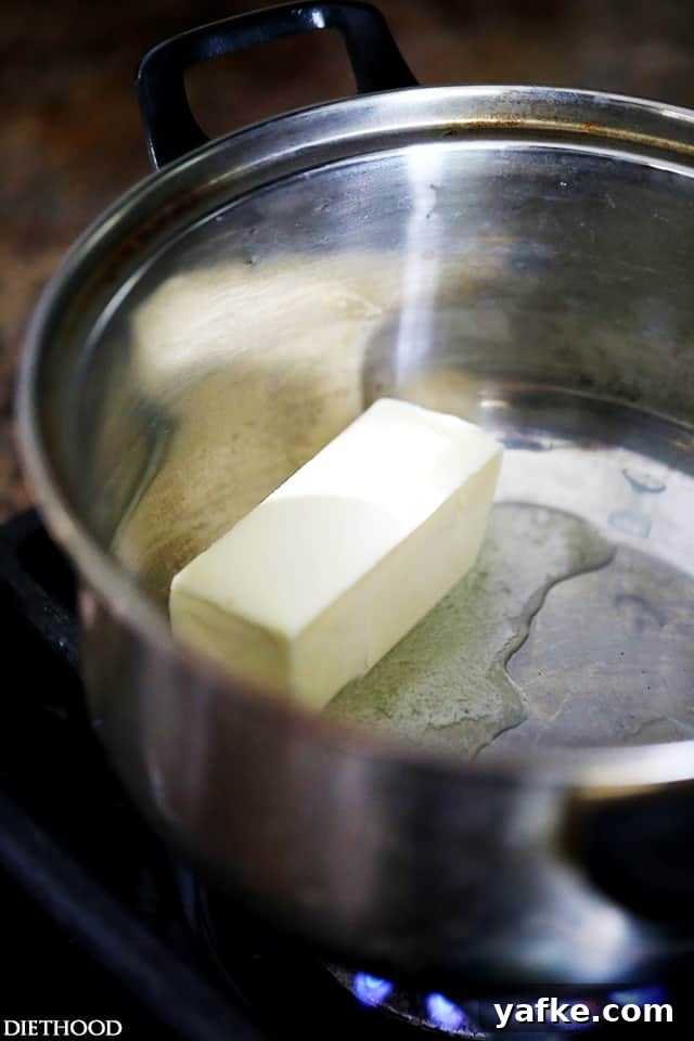 Béchamel sauce is a classic French white sauce made from butter, flour, and milk. Learn how to make béchamel sauce to use in lots of recipes! A stick of butter melting in a saucepan.