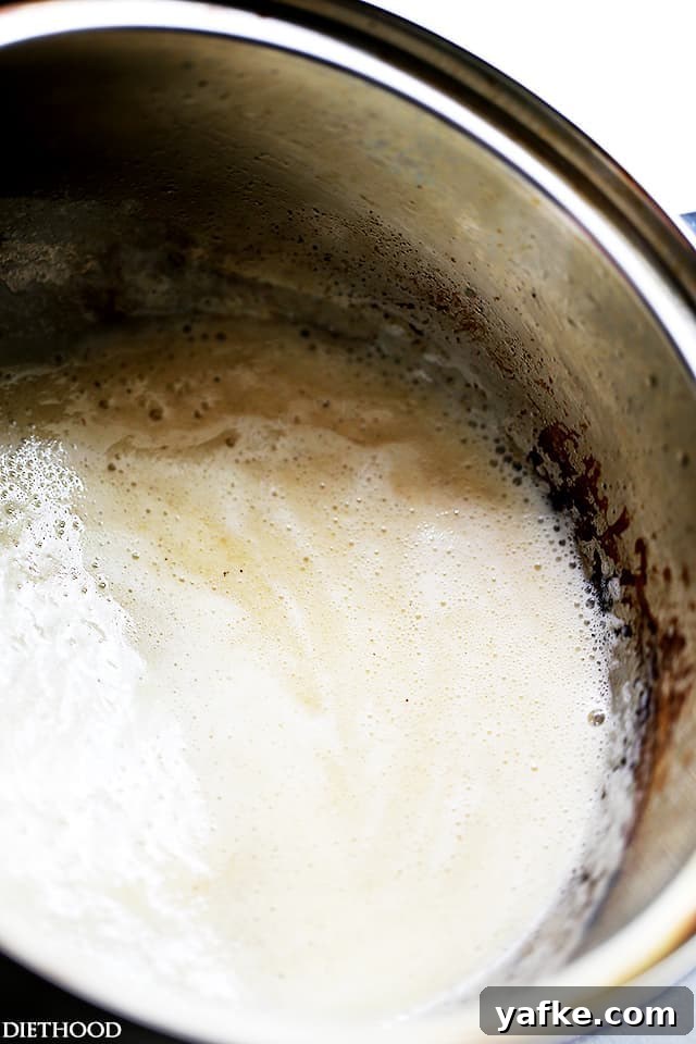Béchamel sauce is a classic French white sauce made from butter, flour, and milk. Learn how to make béchamel sauce to use in lots of recipes! Flour and butter cooking into a roux inside a saucepan.