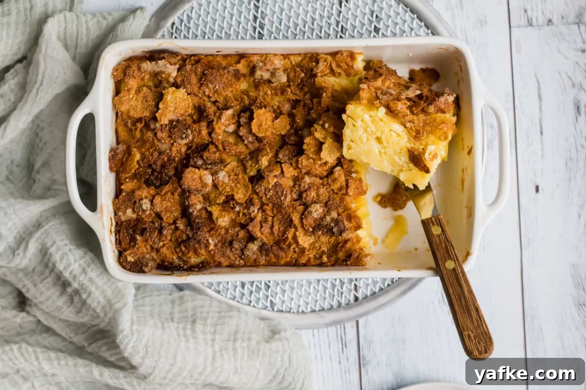 7-Ingredient Sweet Noodle Kugel Recipe 2 noodle kugel in a white baking dish with a piece cut out
