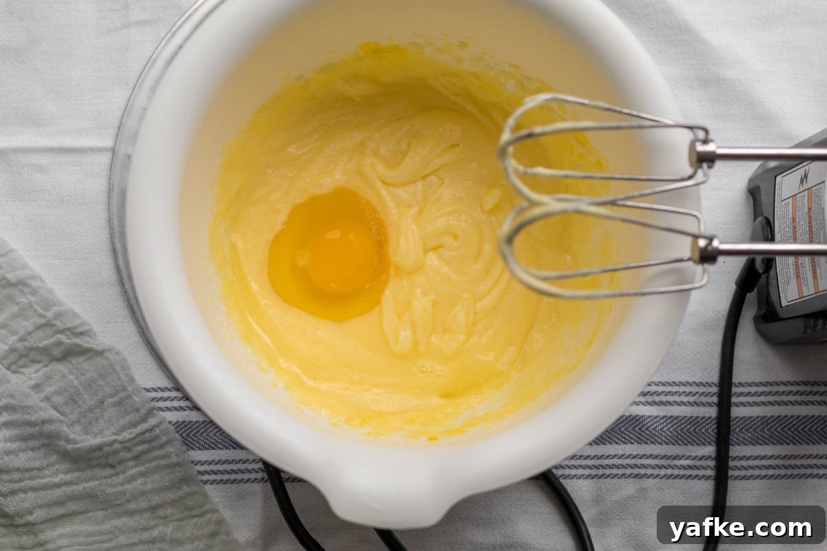 7-Ingredient Sweet Noodle Kugel Recipe 7 eggs being added to kugel custard