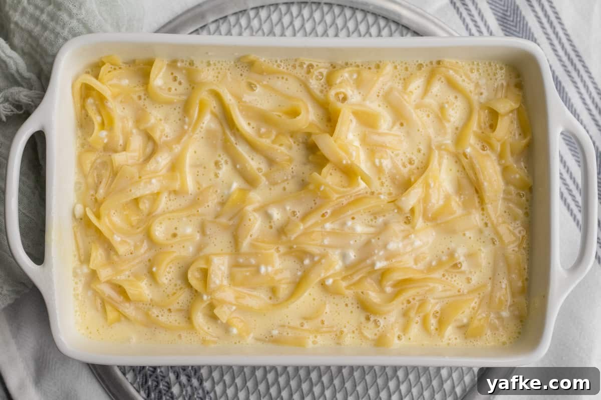 7-Ingredient Sweet Noodle Kugel Recipe 9 noodle kugel in baking pan with no topping