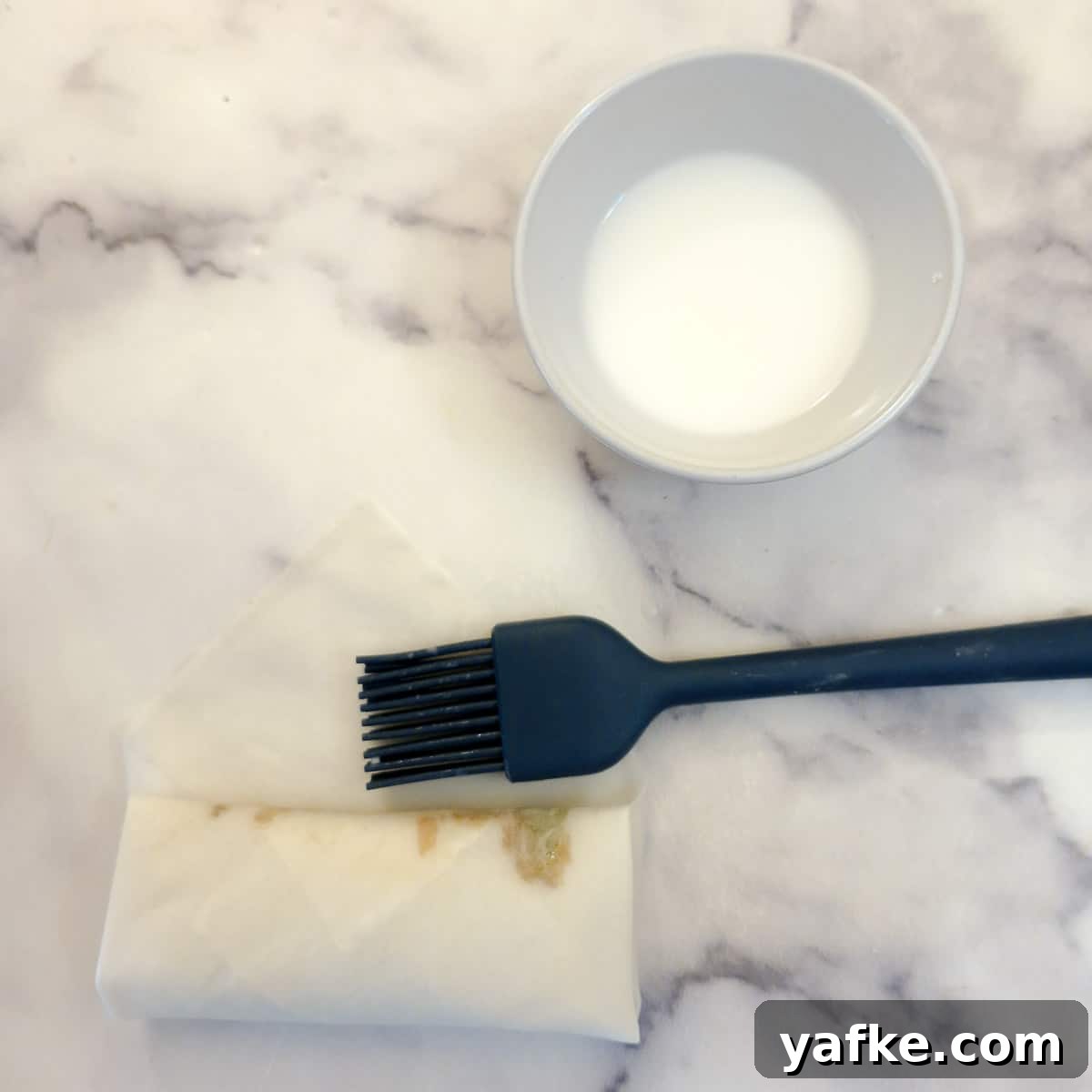 Crispy Prawn Spring Rolls Recipe with Sweet Chili Dip 10 Spring roll being sealed with cornflour slurry.