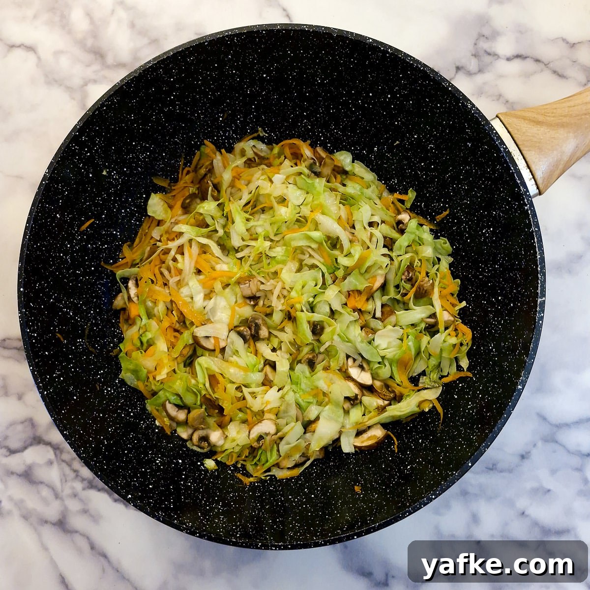 Crispy Prawn Spring Rolls Recipe with Sweet Chili Dip 4 Carrots, cabbage, mushrooms and bean sprouts in a frying pan.
