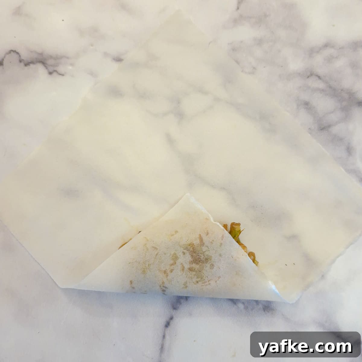 Crispy Prawn Spring Rolls Recipe with Sweet Chili Dip 9 A corner of the spring roll wrapper folded over the filling.