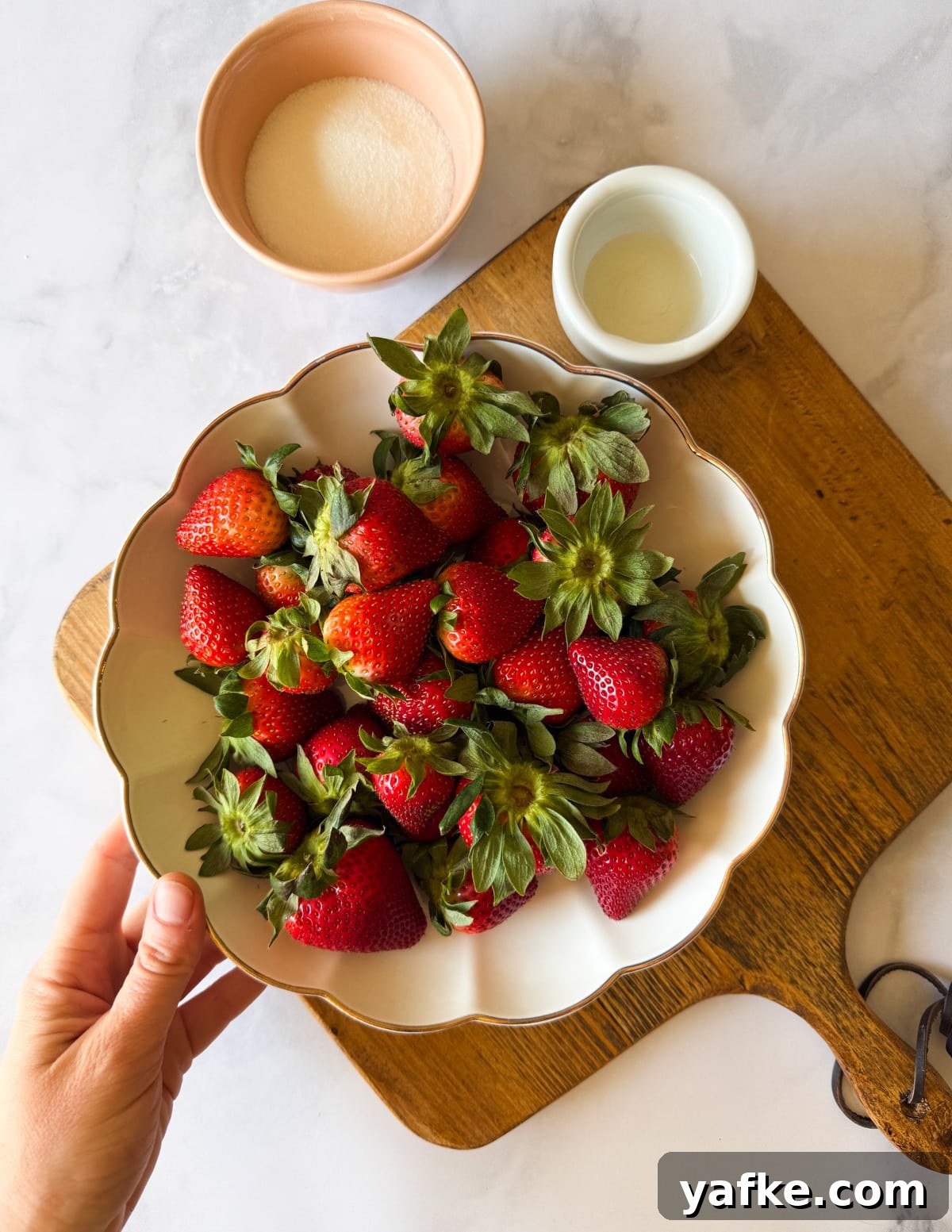 Macerated Strawberries Recipe with Lemon and Vanilla 3 a bowl of strawberries, a bowl of sugar, and lemon juice.