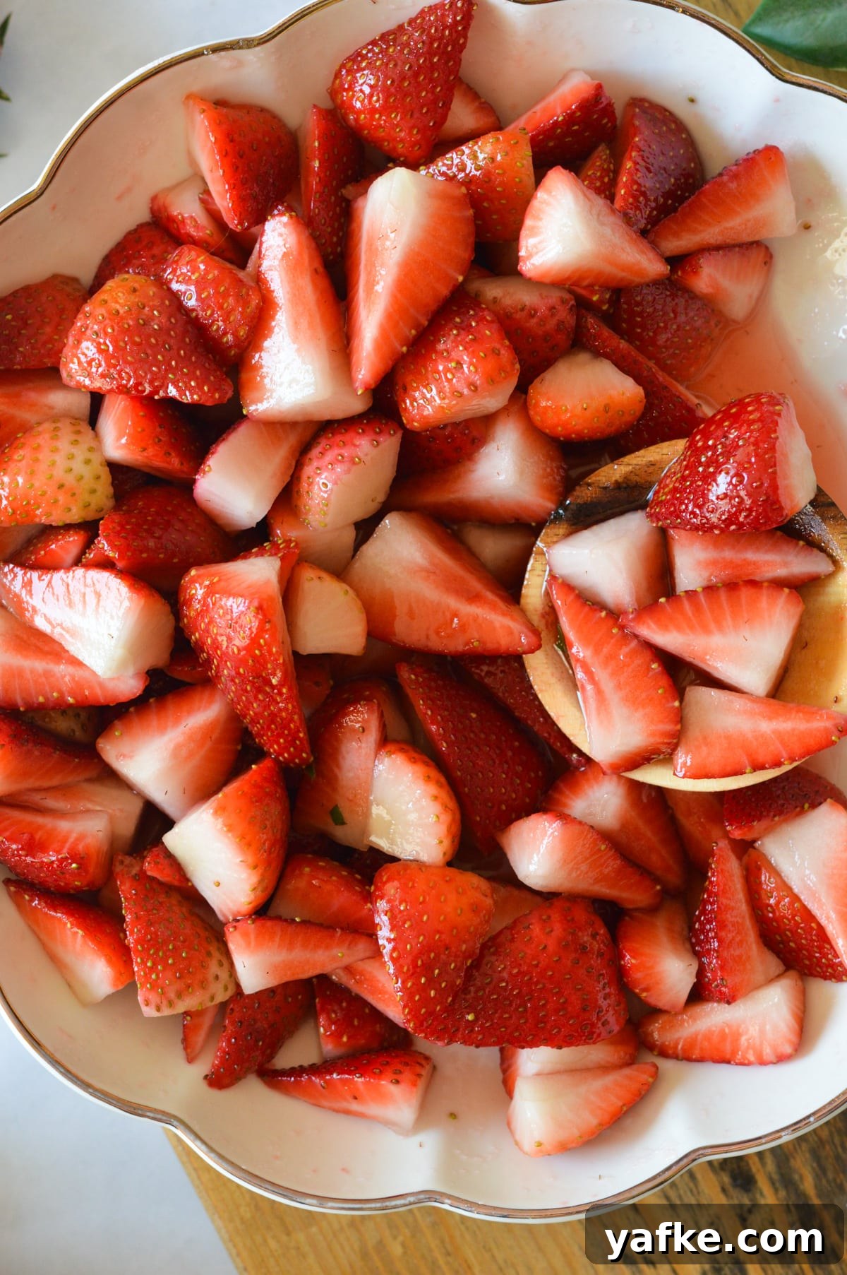 Macerated Strawberries Recipe with Lemon and Vanilla 10 a bowl of macerated strawberries.