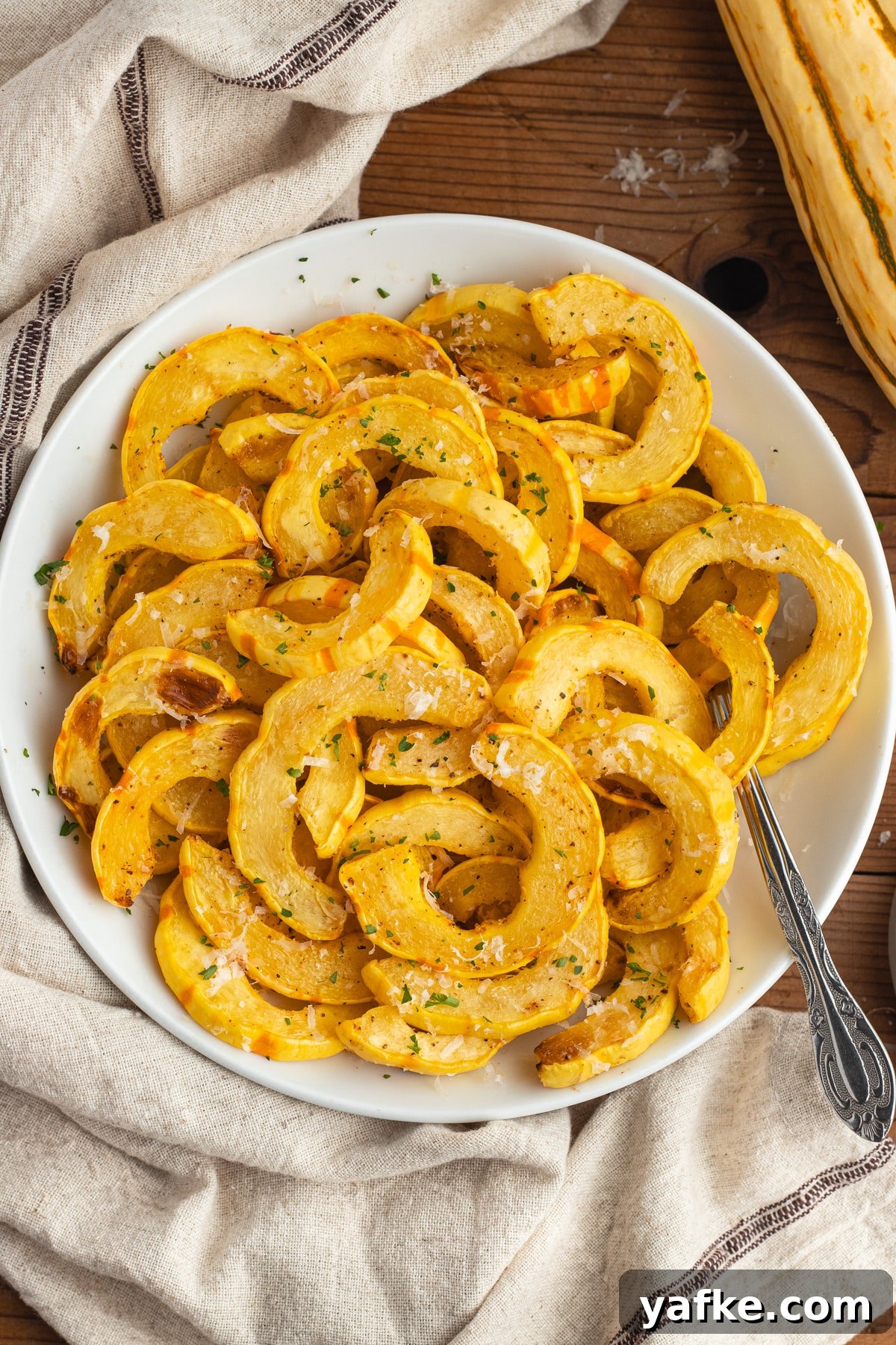 This is a picture of air fried squash on a white plate.