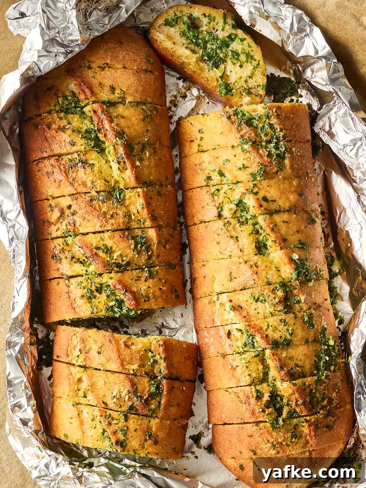 Crispy Garlic Bread Recipe with Herb Butter 2 A foil package with homemade garlic bread inside.