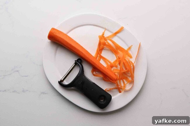 Carrot Spaghetti Recipe: Savory Veggie Noodle Pasta 3 Carrot ribbons being prepared