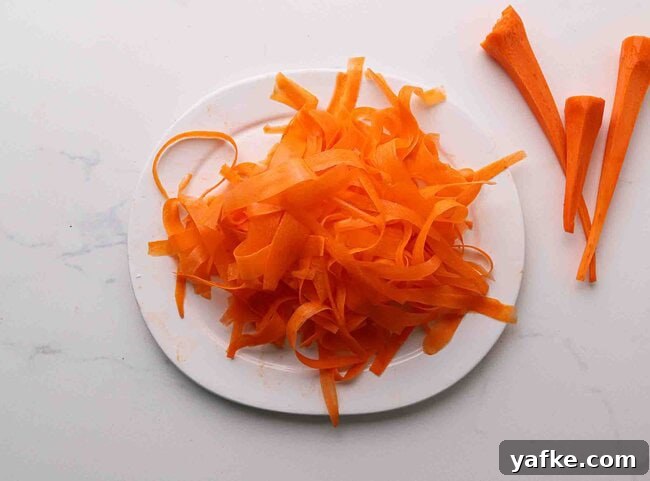 Carrot Spaghetti Recipe: Savory Veggie Noodle Pasta 4 Carrot ribbons on a plate