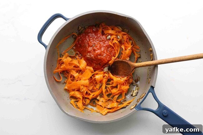 Carrot Spaghetti Recipe: Savory Veggie Noodle Pasta 7 Carrot ribbons with marinara sauce in a pan